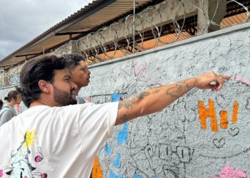 Jovens do Tecendo o Futuro pintam mural coletivo ao lado de artista goiano